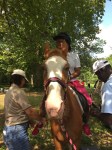 Campers learn about caring for horses and how to ride them