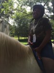 Campers learn about caring for horses and how to ride them