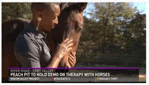 Gwendolyn Coley prepares for the free demo of horses as therapists.