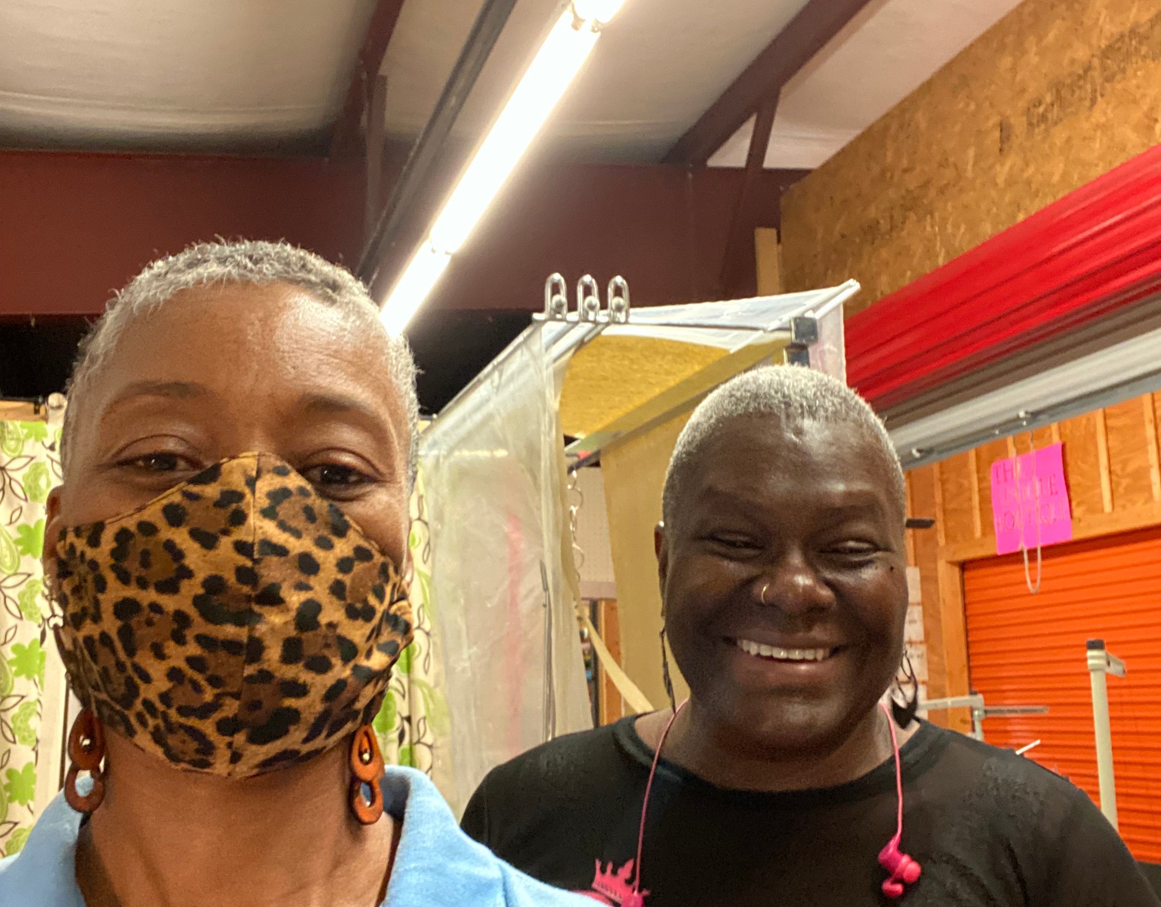 two women, one with a leopard print mask