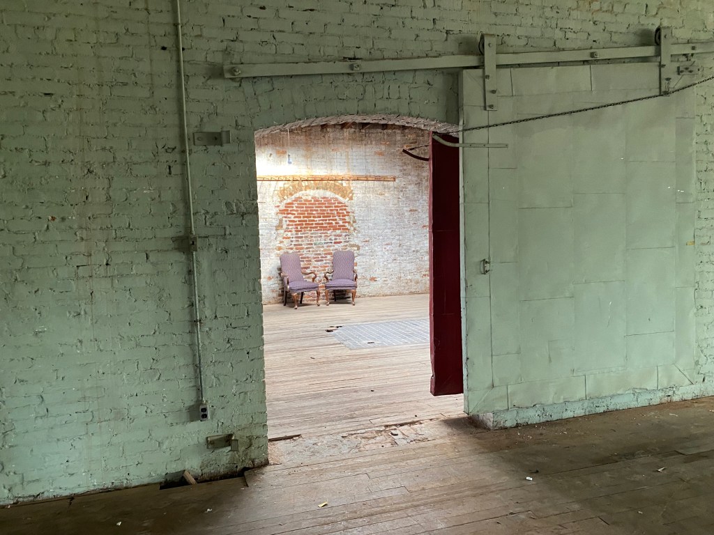 Greemwashed wall with open green fire door