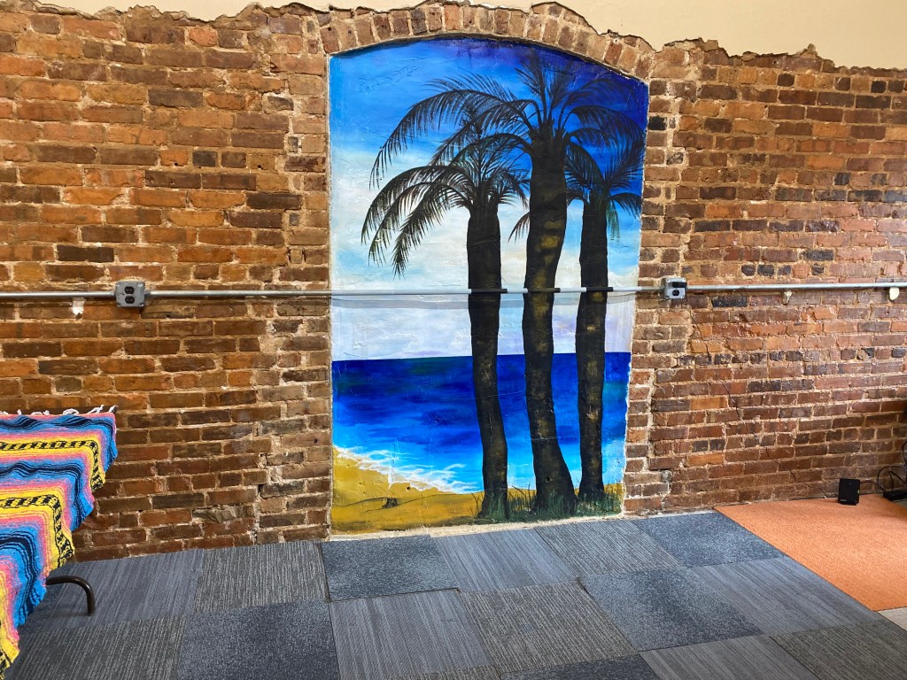 Painted brick archway with palm trees
